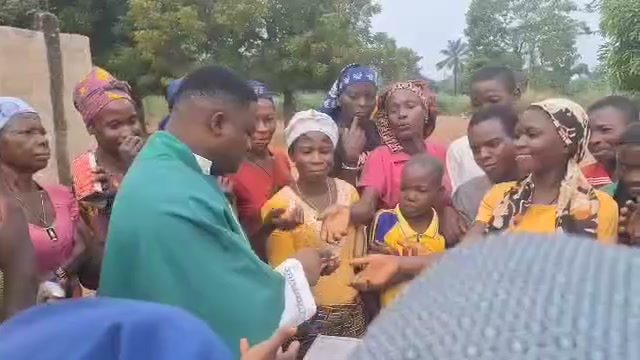 A crowd of community members receiving supplies at an outreach