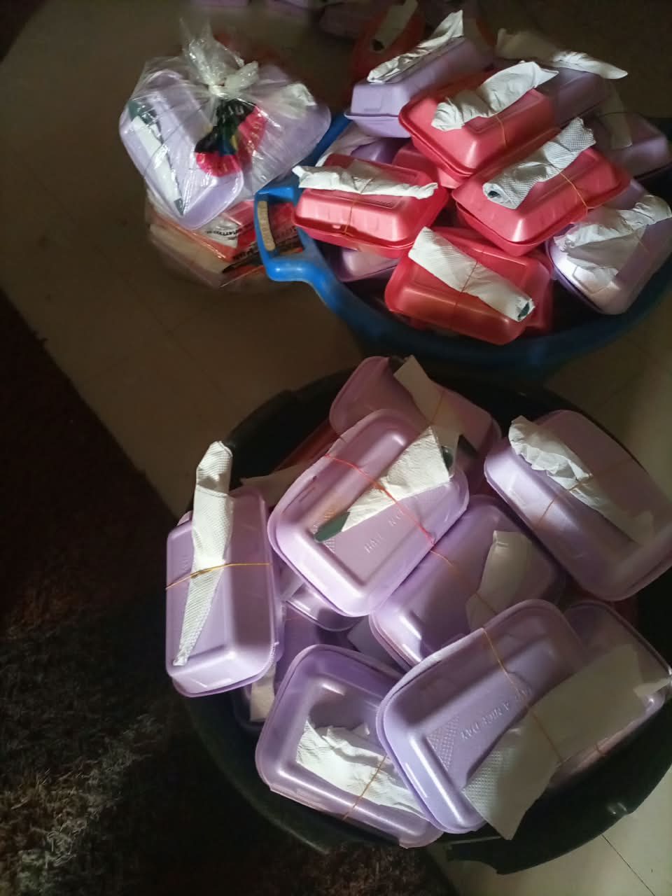 Two large basins filled with packed meals waiting to be loaded out